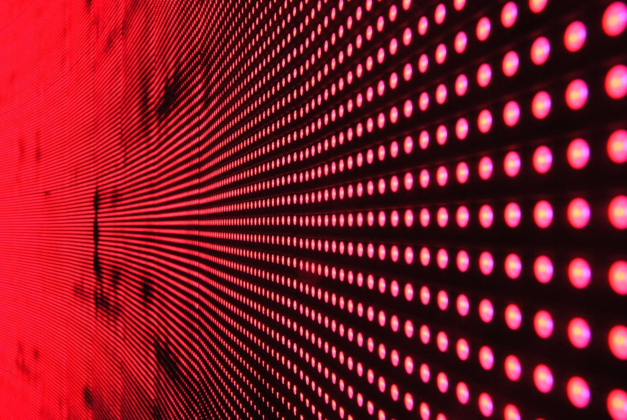 service-06 Vibrant abstract pattern of illuminated red LED lights forming a dynamic design.